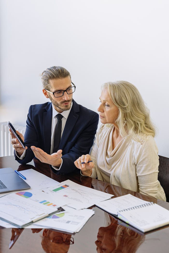 contact-img Professional business discussion between a consultant and client in an office setting.